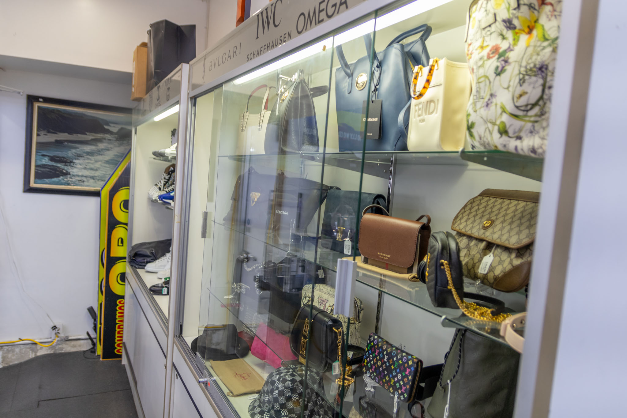 A display case in the Fancy Jewelry & Loan pawnshop showing an assortment of designer items ranging from Gucci Bags to Nike Shoes