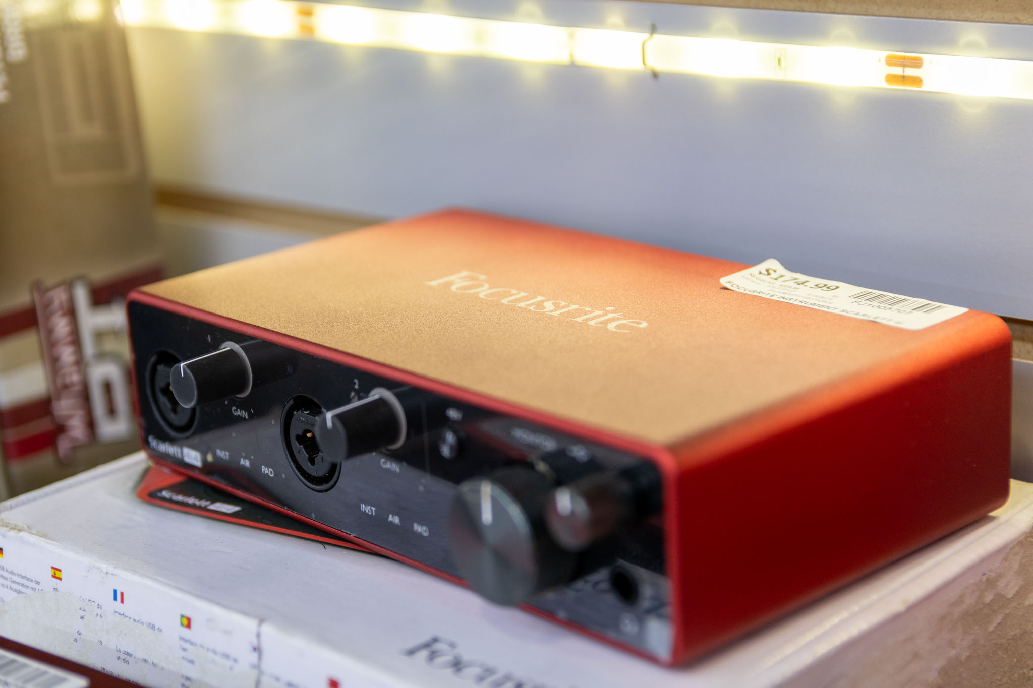 A shelf holding a Focusrite Scarlett USB Audio interface