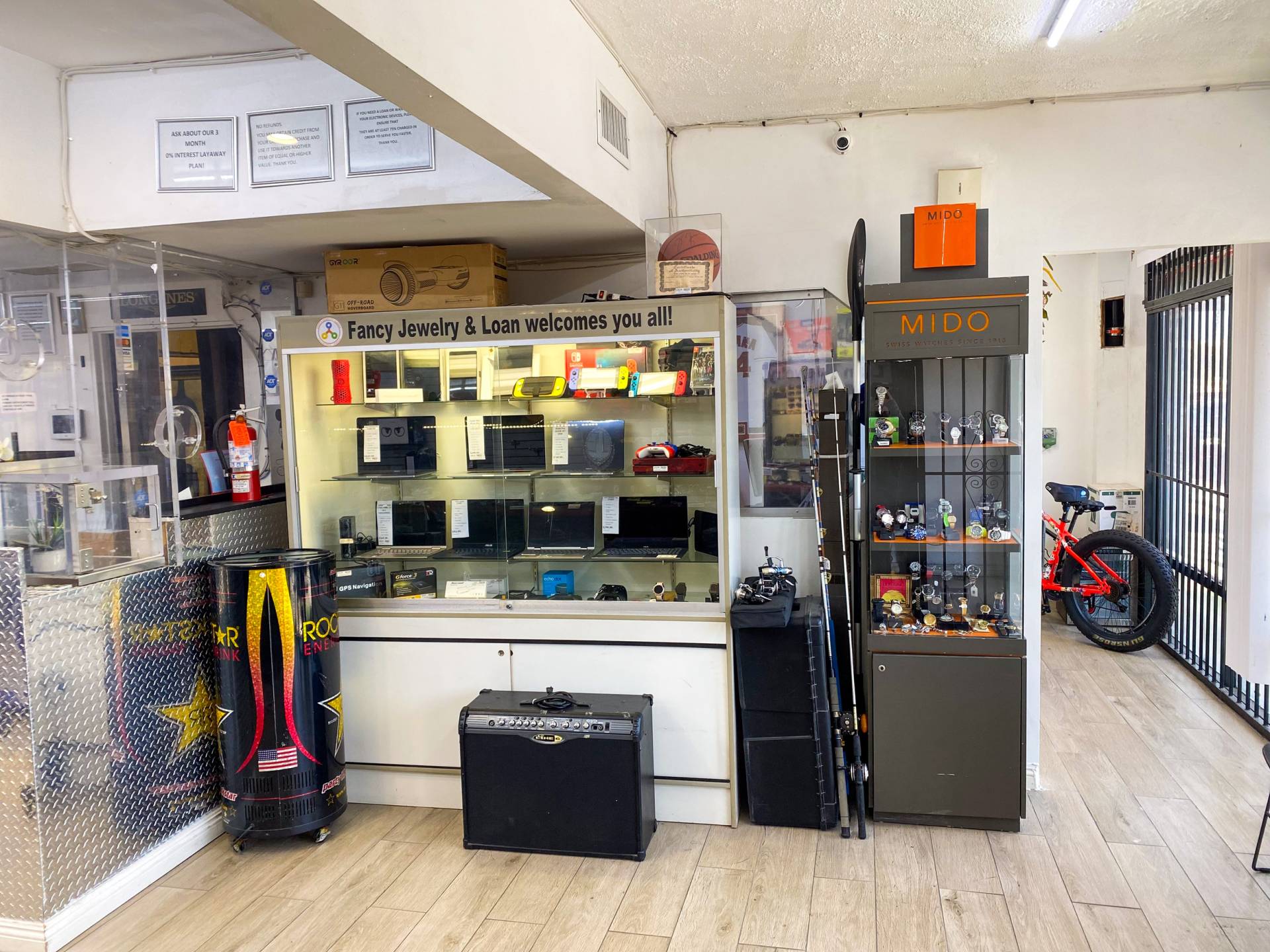 Interior of Fancy Jewelry & Loan. The image shows the watch showcase, along with the Laptop & Electronics Showcase.